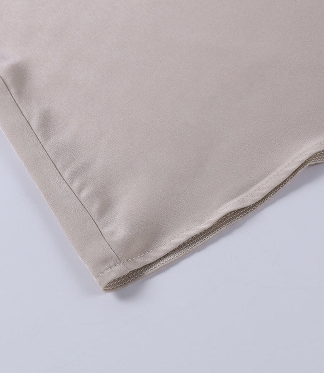 Close-up of the hemline of the champagne maxi slip dress, showcasing the neat stitching and fabric drape.