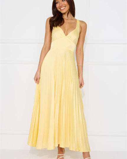 Front view of pale yellow sleeveless maxi dress with wrapped bodice and pleated skirt