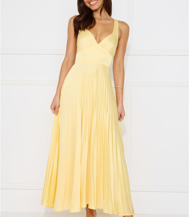 Front view of pale yellow sleeveless maxi dress with wrapped bodice and pleated skirt