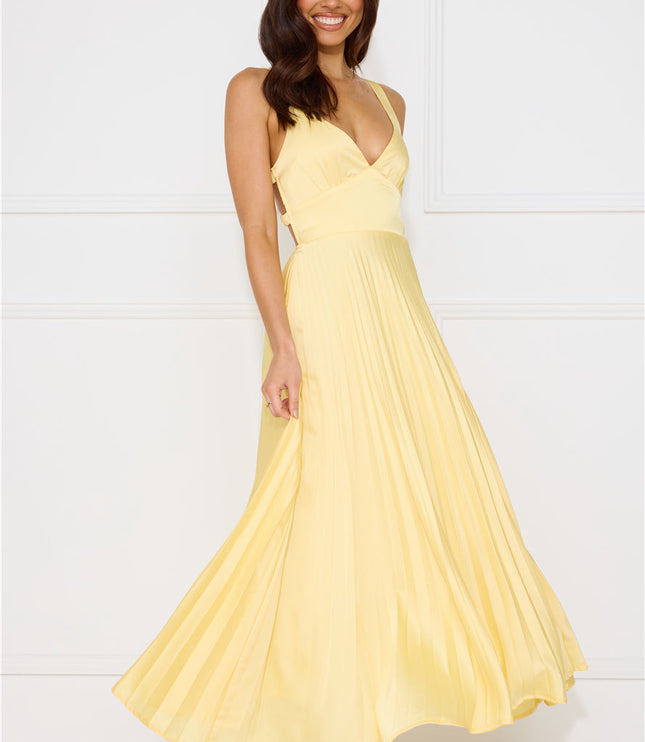 Side profile of yellow maxi dress showing v-neckline and flowing pleated skirt