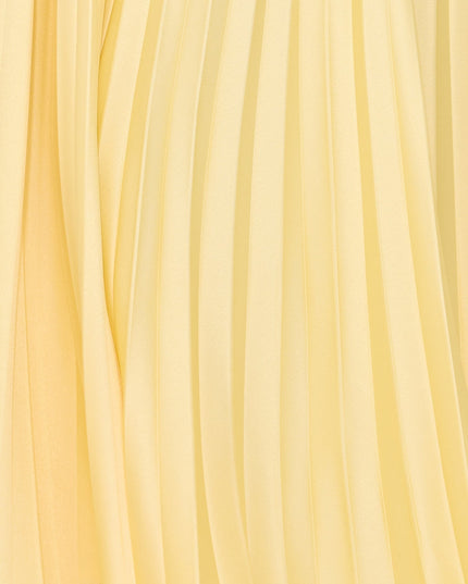 Close-up of pale yellow pleated fabric texture on maxi dress skirt