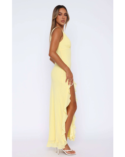 Side view of yellow v-neck sundress with flowing ruffled skirt