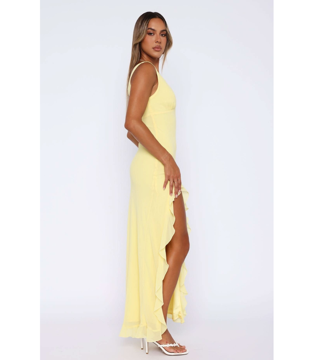 Side view of yellow v-neck sundress with flowing ruffled skirt