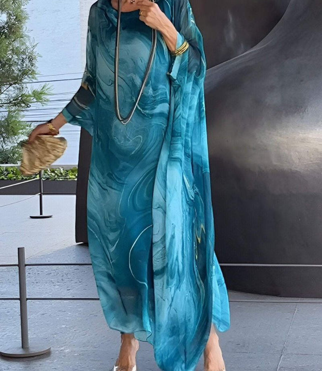 Teal abstract print maxi dress with sheer sleeves and flowing vacation style