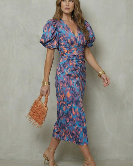 Side angle of women's abstract puff sleeve midi dress showing fit and V-neckline