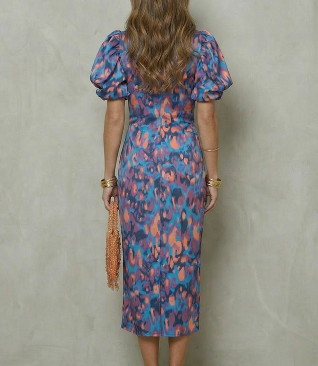 Back view of abstract print midi dress with puff sleeves and fitted silhouette