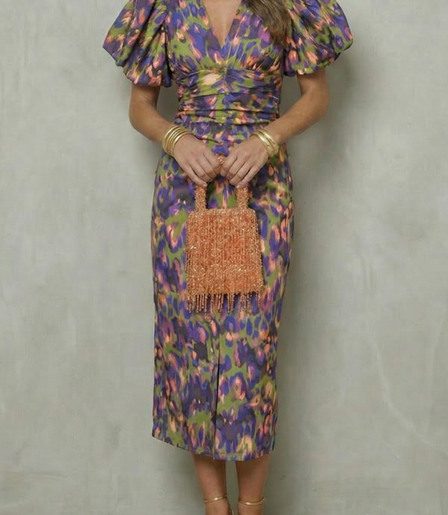Women's abstract puff sleeve midi dress in green, purple, and gold tones with ruched waist