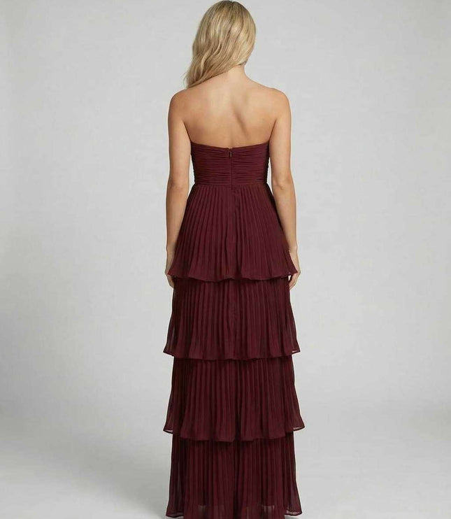 Back view of burgundy strapless maxi dress with smocked bodice and tiered layers