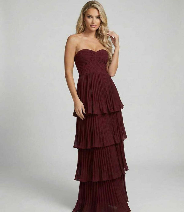 Burgundy strapless maxi dress shown from back with flowing tiered skirt detail