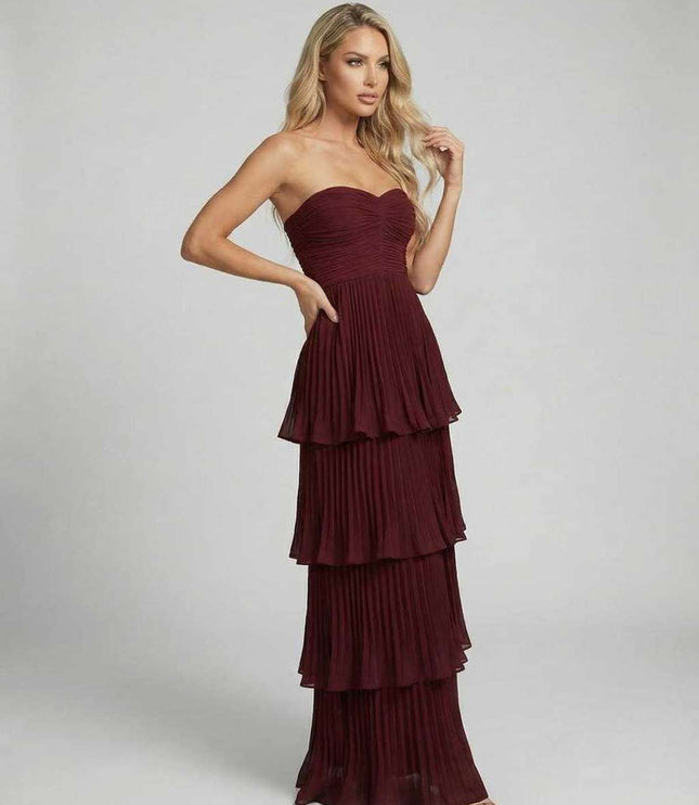 Angled view of burgundy strapless wedding guest maxi dress with tiered chiffon layers