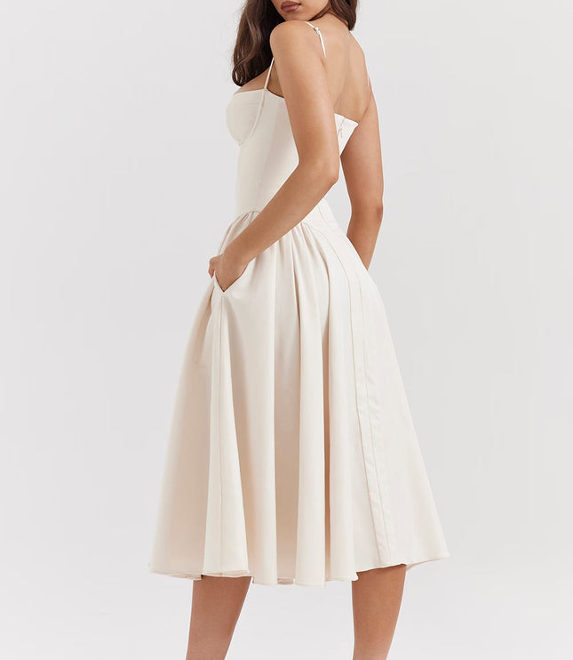 Side view of cream midi dress showing straps, open back and gathered skirt