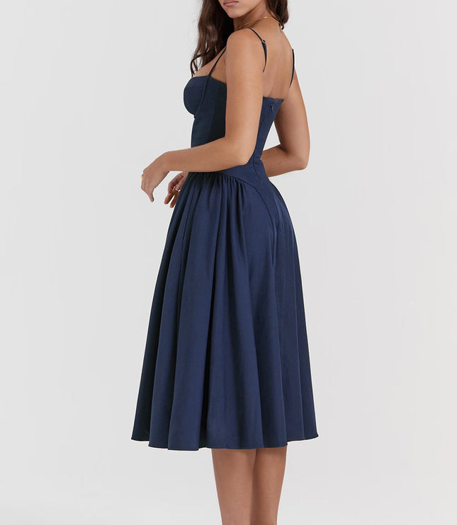 Back side view of navy midi dress with open back, straps, and voluminous skirt
