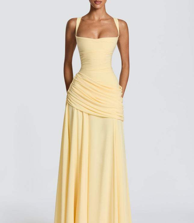 Close-up of pale yellow cowl neck maxi dress with wide straps and ruched waist drape