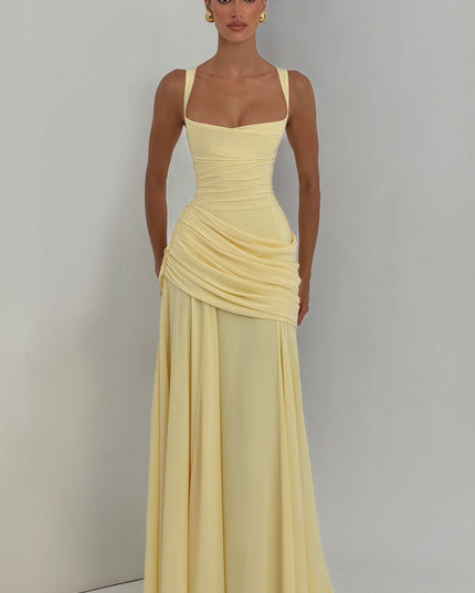 Front full-length pale yellow wedding guest maxi dress with cowl neckline and draped skirt