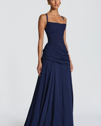 Back view navy maxi dress with crisscross straps and lace-up corset back, ruched hip detail