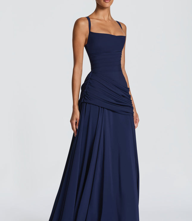Back view navy maxi dress with crisscross straps and lace-up corset back, ruched hip detail