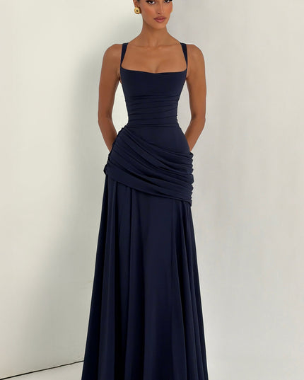 Full-length navy wedding guest maxi dress with draped ruched hip panel and flared hem