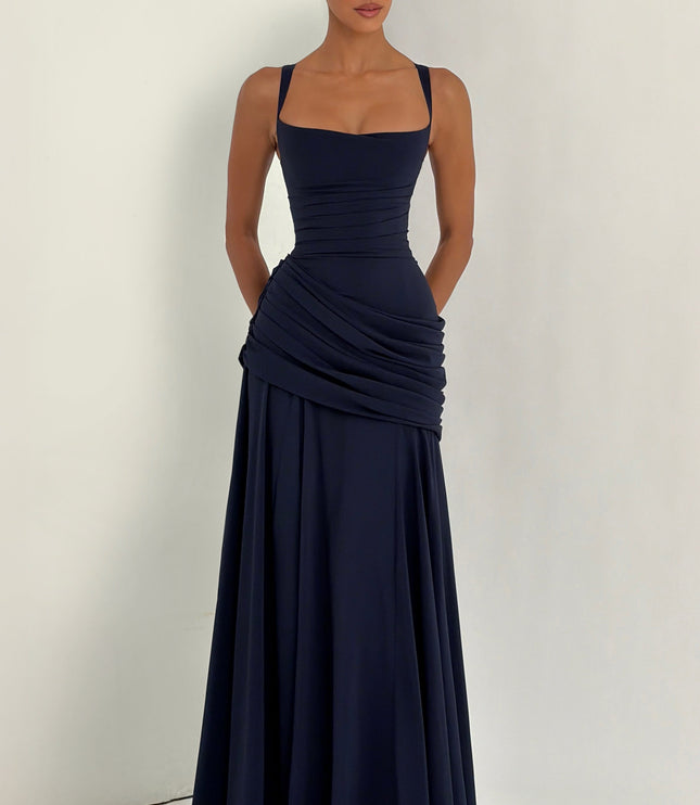 Full-length navy wedding guest maxi dress with draped ruched hip panel and flared hem