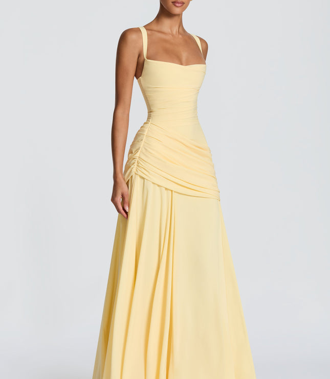 Back view pale yellow maxi dress with crisscross straps and lace-up corset back, ruched skirt