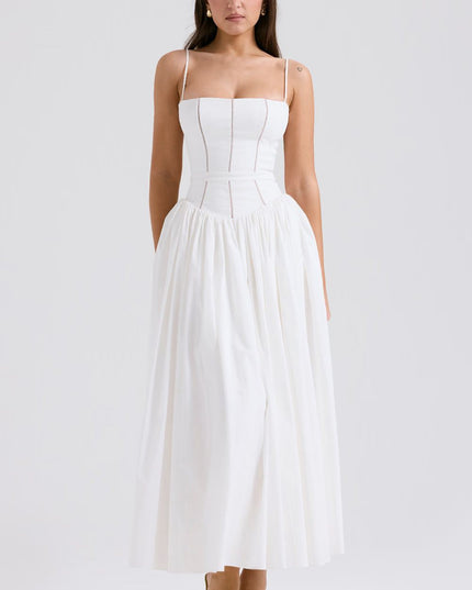 Front view of a white corset midi dress with spaghetti straps and soft pleated skirt