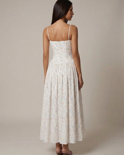 Back view of women's floral corset midi dress with open upper back, fitted waist, and pleated skirt