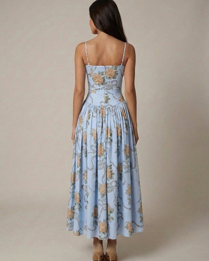 Side view of blue floral midi dress with corset-style bodice, spaghetti straps, and soft full skirt