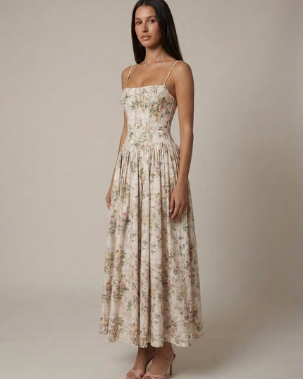 Women's beige floral corset midi dress with delicate pink flowers, structured bodice, and flowing skirt