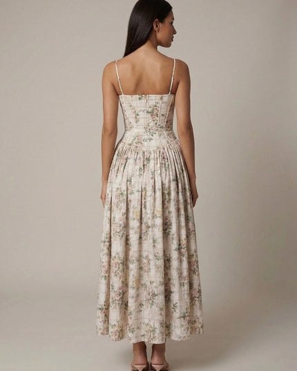 Side view of beige floral midi dress with corset seams, thin straps, and gathered waist detail