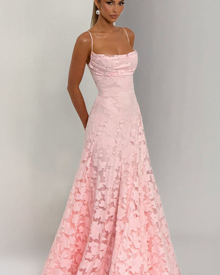 Side profile pink floral maxi dress with flowing skirt and side pockets