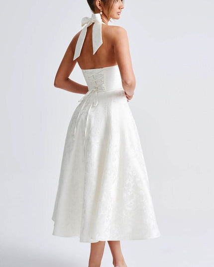 Back view of white halter dress showing lace-up corset detail