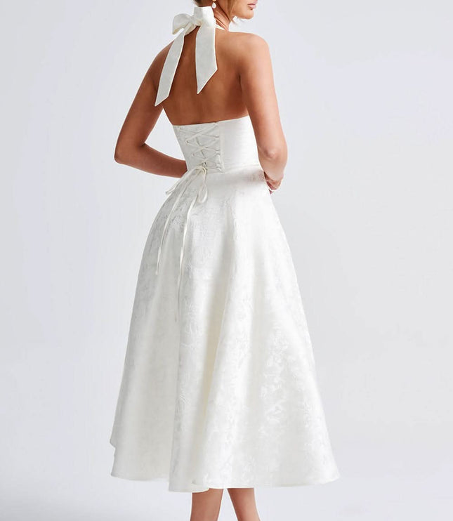 Back view of white halter dress showing lace-up corset detail