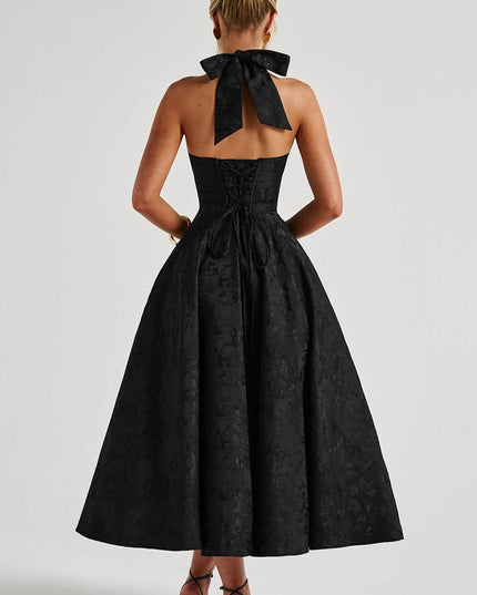 Back view of black halter dress with bow tie detail