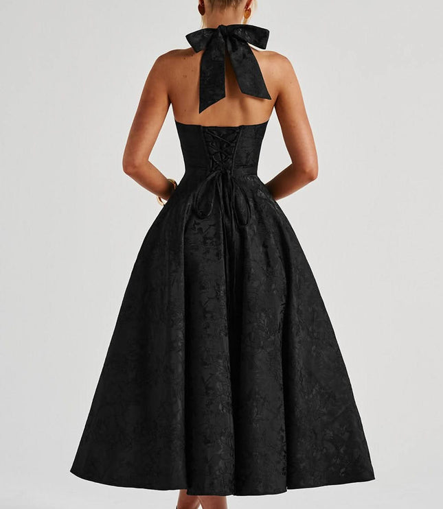 Back view of black halter dress with bow tie detail
