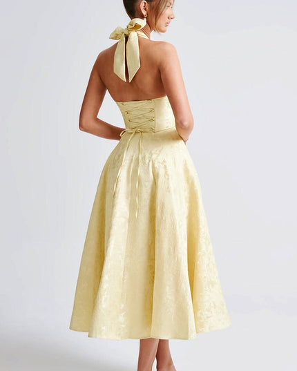Back view of pale yellow halter dress with lace-up corset detail