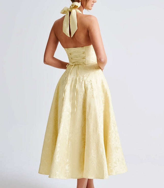 Back view of pale yellow halter dress with lace-up corset detail