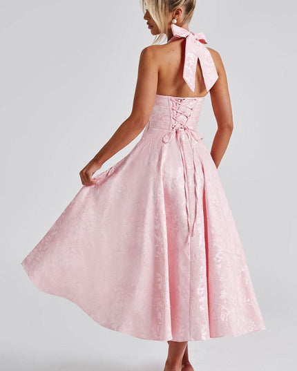 Back view of blush pink halter dress with tied bow closure