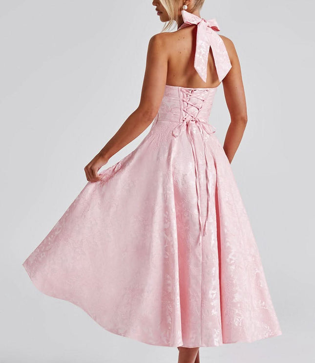 Back view of blush pink halter dress with tied bow closure
