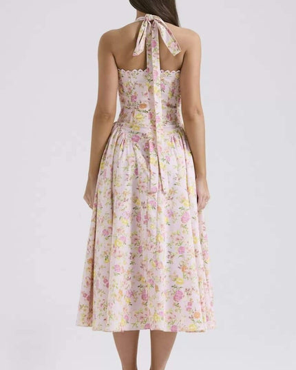 Back view of floral halter midi dress with tie neck, smocked back, and flowing skirt