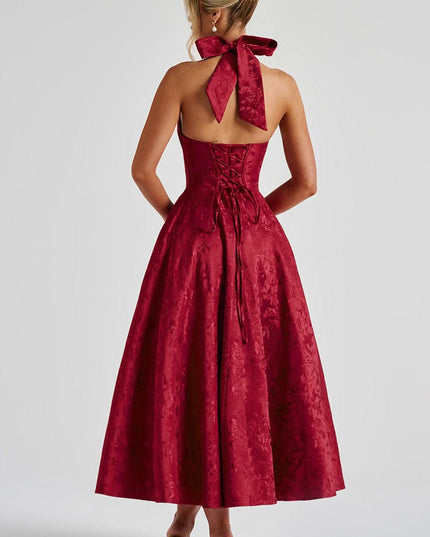 Back view of burgundy velvet halter dress with bow and lace-up