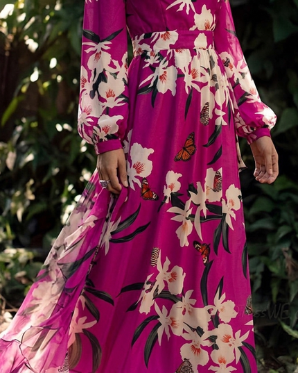 Lower half of magenta floral maxi dress with sheer overlay, gathered waist, and flowing skirt