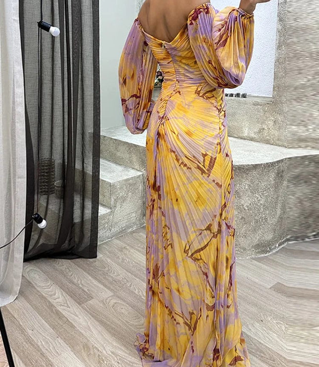 Back view of floral off shoulder maxi dress with long puff sleeves and flowing skirt