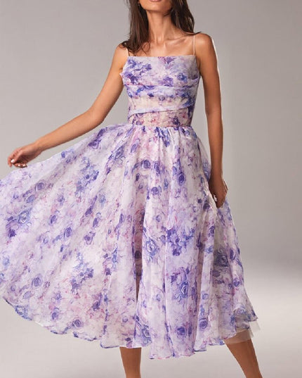 Purple floral midi dress with square neckline, sheer waist cutout, and flowing skirt