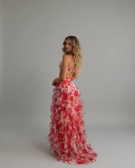 Side view of floral spaghetti strap maxi dress with open back and flowing ruffles