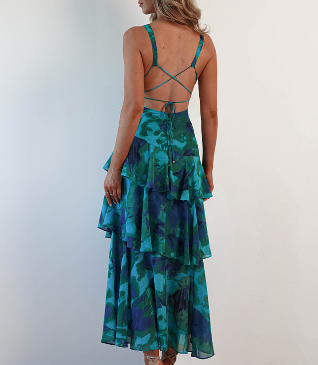 Back view of teal and navy floral tiered ruffle maxi dress with crossback straps