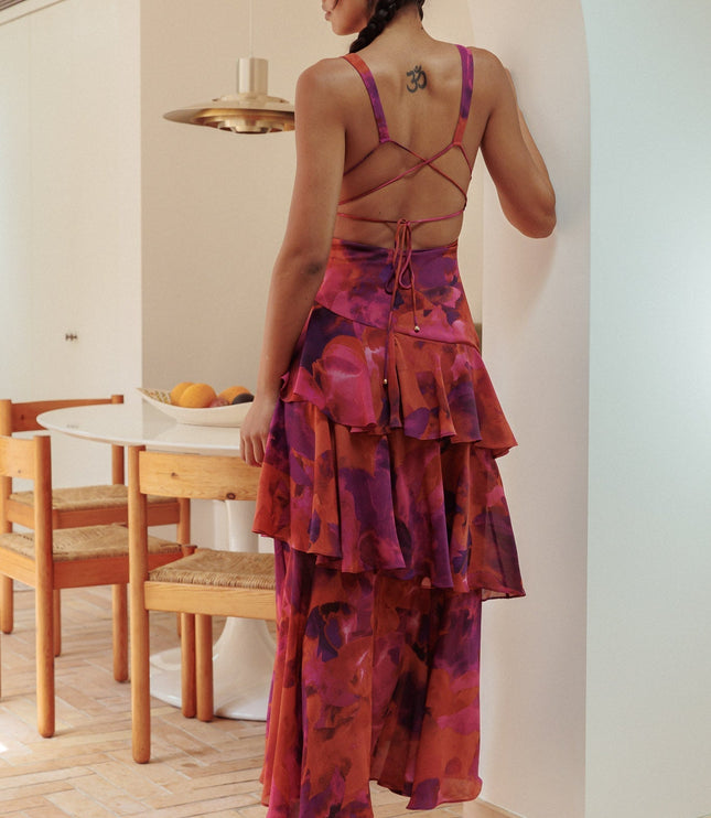 Back view of red and purple floral maxi dress with crossback straps and ruffle layers