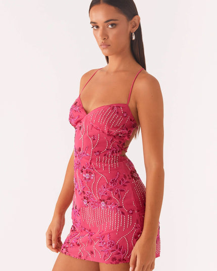 Side angle of pink wedding guest mini dress showing fitted floral sequin detail