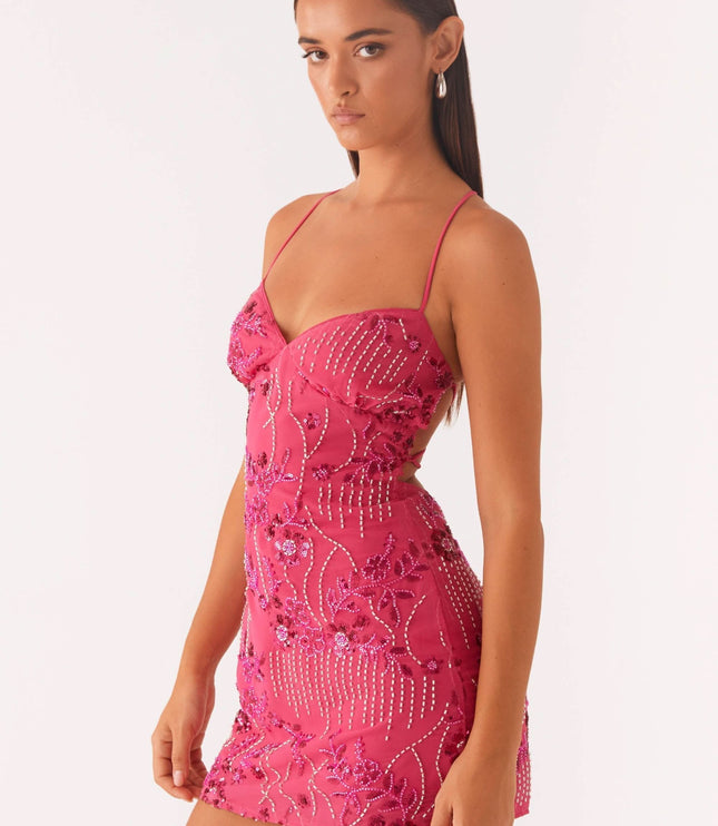 Side angle of pink wedding guest mini dress showing fitted floral sequin detail