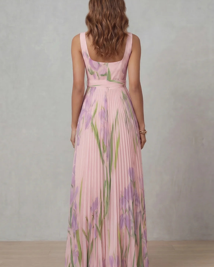 Side profile of a pink floral maxi dress with square neck, fitted waist, and full pleated skirt