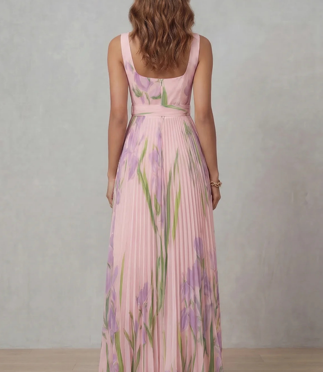 Side profile of a pink floral maxi dress with square neck, fitted waist, and full pleated skirt