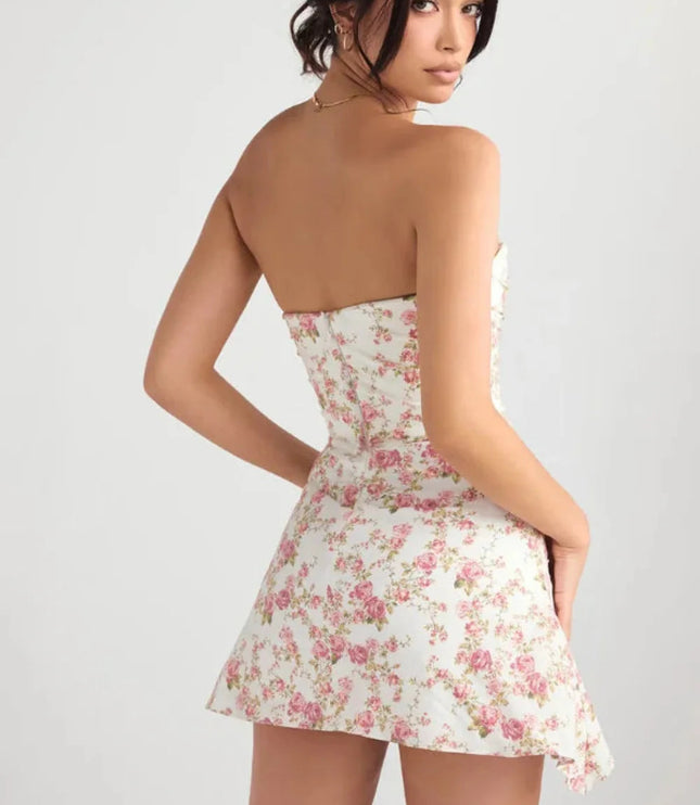 Back view of a floral strapless mini dress with smooth fitted silhouette and side drape detail